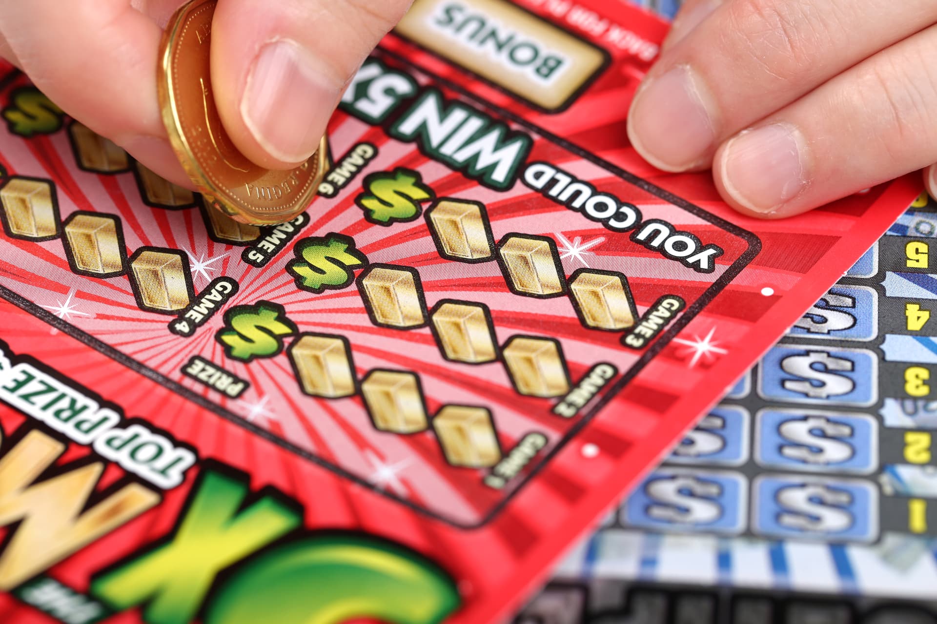 A player scratching an instant lottery ticket